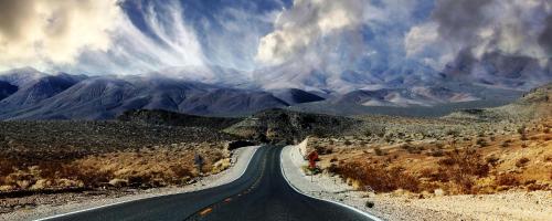 an empty road in the middle of the desert at Stovepipe Wells Village in Death Valley