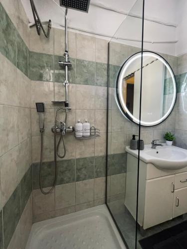 a bathroom with a shower and a sink at Callisti Lux Apartment in Nei Poroi