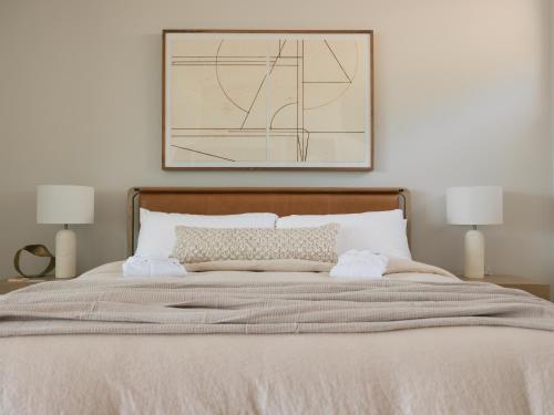 a bedroom with a bed with a picture on the wall at Bialto Bed and Breakfast in Penticton