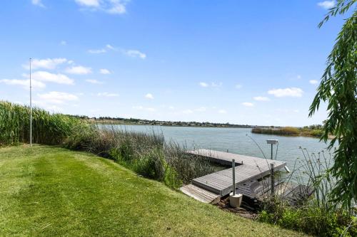 a dock on the side of a lake at Lakefront Washington Home with Private Pool and Sauna in Moses Lake