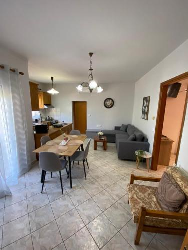 a living room with a table and a couch at Koutrakis apartment in Limenas