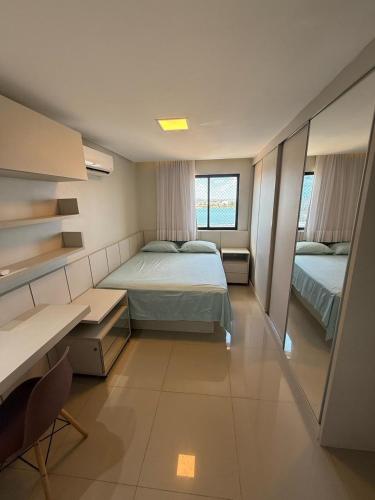 a bedroom with two beds and a desk and a desk at Charme com vista pro Rio, excelente localização in Petrolina