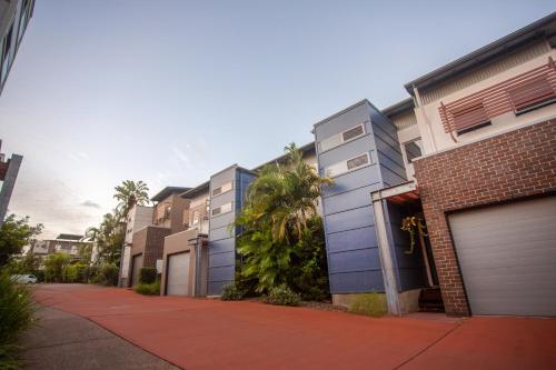 a row of apartment buildings with garages at Quarterdecks Retreat in Hervey Bay