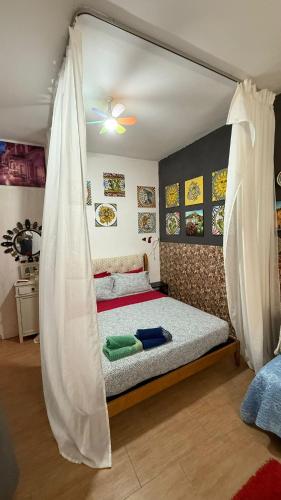 a bed with a canopy in a room at OPEN SPACE in Augusta