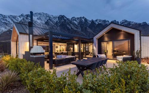 a house with a view of a mountain at Luxury Architectural Home with Pool, Spa and Sauna in Queenstown Airport