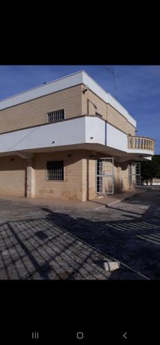 a large brick building with a white roof at Casa Vacanze Errico in Pulsano