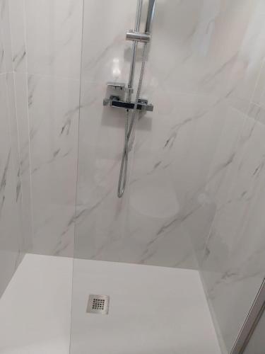 a bathroom with a shower with a glass door at Queen apartment in Ravenna