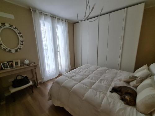 a dog laying on a bed in a bedroom at Queen apartment in Ravenna