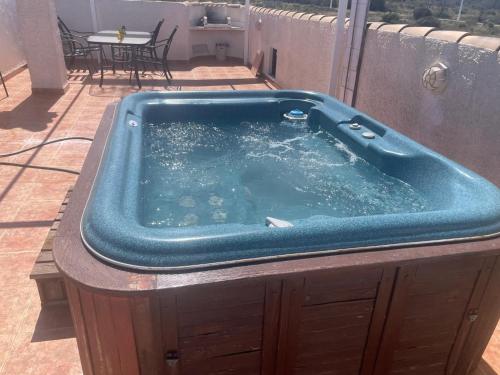 a jacuzzi tub sitting on top of a patio at house with flowers in Gran Alacant