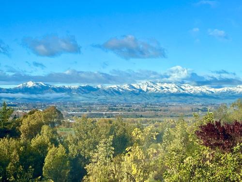 a view of snow capped mountains in the distance at Treetops in Blenheim