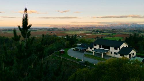 an aerial view of a house on a hill at Treetops in Blenheim