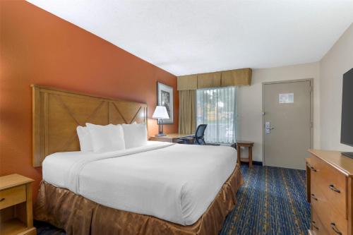 a hotel room with a large bed and a window at Best Western Dulles Airport Inn in Sterling