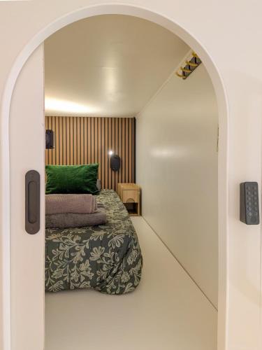 a small bedroom with a bed and an archway at Brimfield Stay in Los Angeles