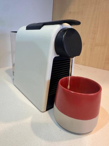 a toaster sitting on a counter next to a cup at Alpine Lake Motel in Taupo