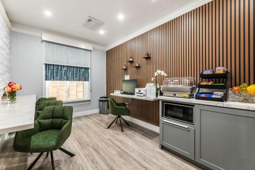 a kitchen with a counter and a table and chairs at Lumea by the Sea in Long Beach