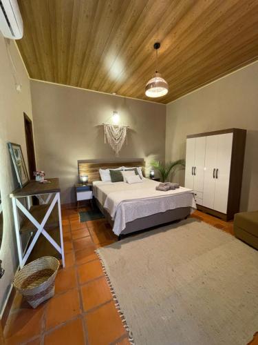 a bedroom with a bed and a wooden ceiling at Colonial-style house in Villarrica