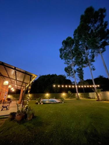 a backyard with a tent and lights at night at Colonial-style house in Villarrica