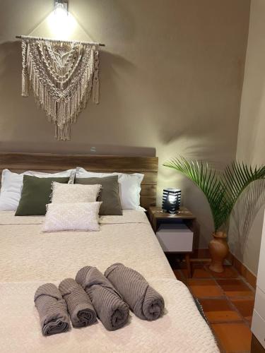 a bedroom with a bed with three pillows on it at Colonial-style house in Villarrica
