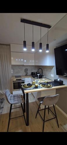 une cuisine avec une table et deux chaises ainsi qu'une télévision dans l'établissement Lovely 1 bedroom vacation home with free parking., à Nice