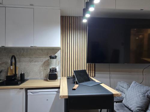 un ordinateur portable assis sur une table dans une cuisine dans l'établissement Lovely 1 bedroom vacation home with free parking., à Nice