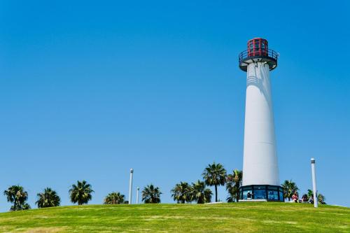a lighthouse on top of a hill with palm trees at Lumea by the Sea in Long Beach