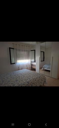 a large bedroom with a bed and a window at Casa Vacanze Errico in Pulsano