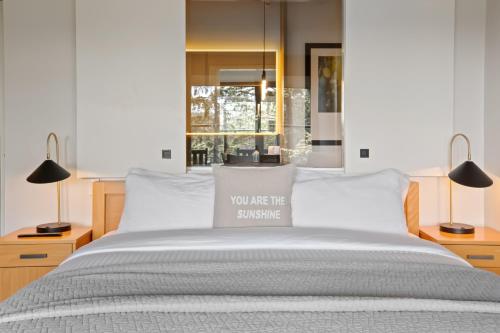 a bed with a pillow that says you are the sunshine at Black Rock Oceanfront Resort in Ucluelet