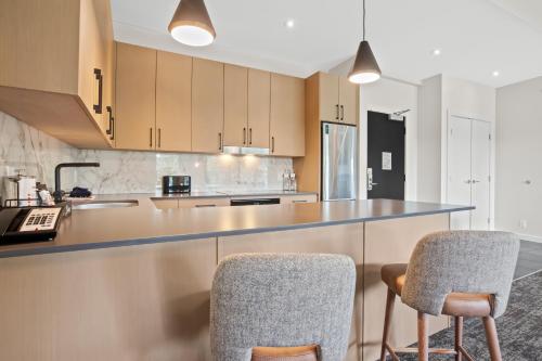 a kitchen with two chairs and a counter top at Black Rock Oceanfront Resort in Ucluelet