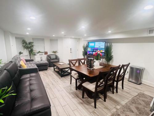a living room with a couch and a table and a television at ComfiNook Stay in Capitol HillWalk to DC Sites in Washington, D.C.