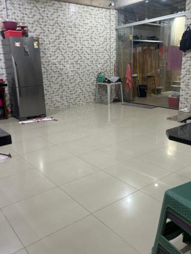 a white tile floor in a room with a refrigerator at Casa cidade nova in Ananindeua