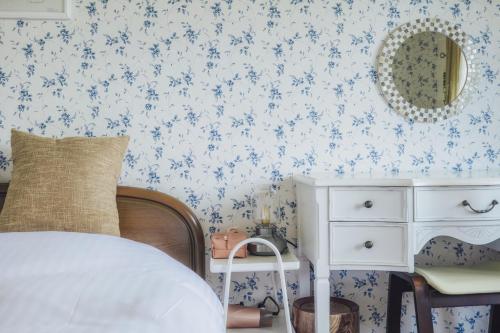 a bedroom with a bed and a dresser with a mirror at 伊豆集 Episode IZU in Ito