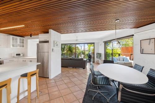 a kitchen and living room with a table and chairs at 16KAT Holiday Noosa Style, Great location, Pet Friendly in Noosa Heads