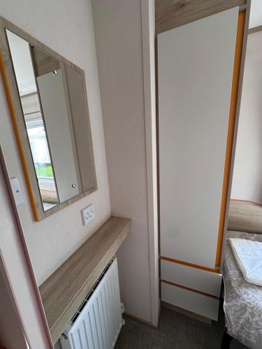 a small room with a mirror and a bed at Relax&Dreams caravan in Port Seton