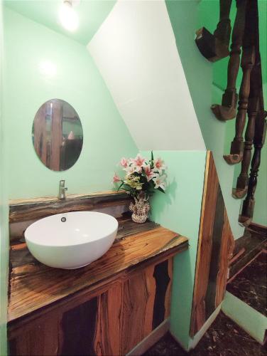 a bathroom with a sink and a mirror on a counter at Blue Lagoon Inn and Restaurant, Pagudpud in Mabubua