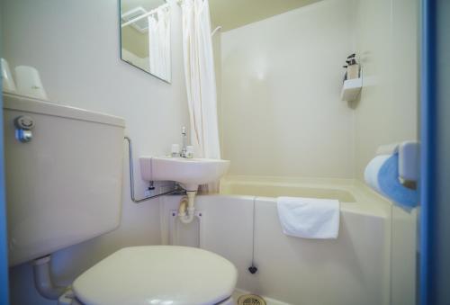 a small bathroom with a toilet and a sink at 伊豆集 Episode IZU in Ito