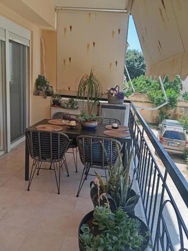 a patio with a table and chairs on a balcony at Elite and Style in Preveza