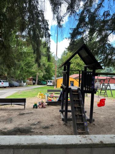 a playground with a slide and a bench at Solo tábořiště, kemp u vody, Nová Živohošť in Křečovice