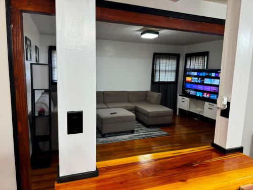 a living room with a couch and a tv at Centralized Modern Home in Johnson City in Johnson City