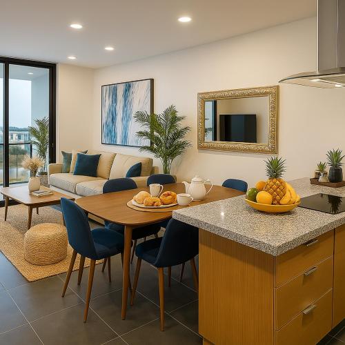 a kitchen and living room with a table and a couch at Malecón de Mazatlan Vista al mar Alberca Infinity Jacuzzi Gym in Mazatlán
