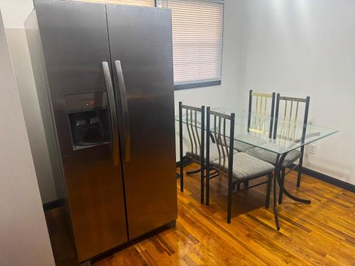 a refrigerator and a table in a room at Centralized Modern Home in Johnson City in Johnson City