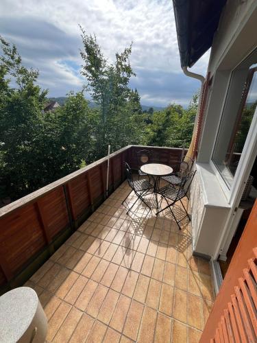 a patio with a table and chairs on a balcony at Kontinental in Bad Harzburg
