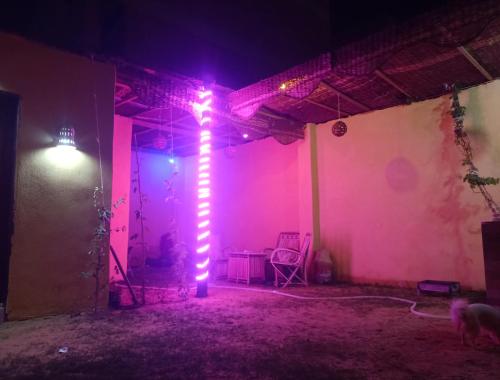 a lit up room with a light pole in a room at Saqqara tent in Cairo