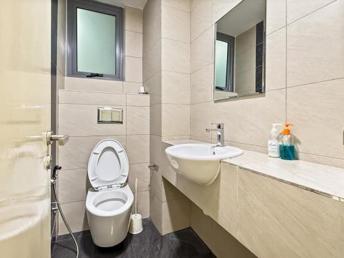 a bathroom with a toilet and a sink at Trifirah Homestay in Kota Kinabalu