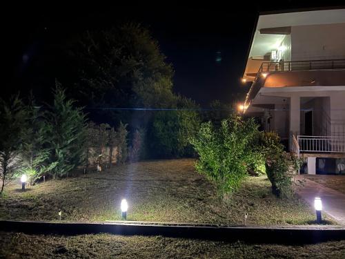 a garden at night with lights in front of a house at Villa Fjorentin Berat in Berat