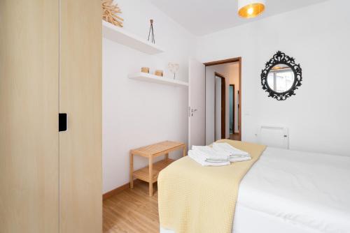 a bedroom with a table and a mirror on the wall at Renovated 3BR Apt Near City Hotspots with Great Value in Porto