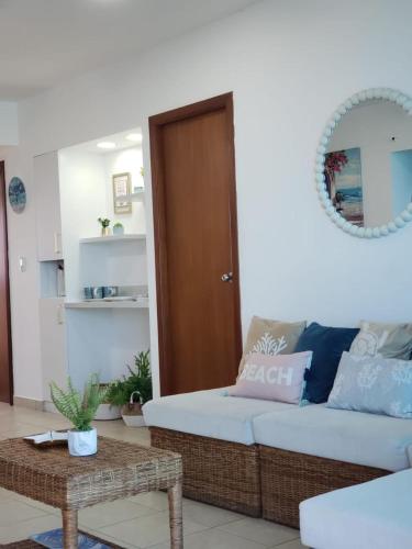 a living room with a couch and a table at Departamento con piscina 8 in Salinas