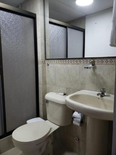 a bathroom with a toilet and a sink at Departamento con piscina 8 in Salinas