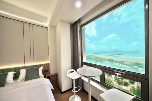 PingTan YuCheng Seaview Blue Smart Hotelにあるベッド