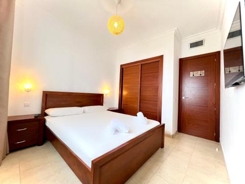 a bedroom with a large bed with white sheets at Coastal Elegance - Bella Vista in Cabo Negro
