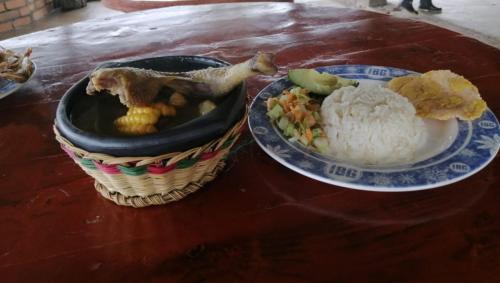 a table with a basket of food and a plate of rice at Las Bromelias in Coconuco